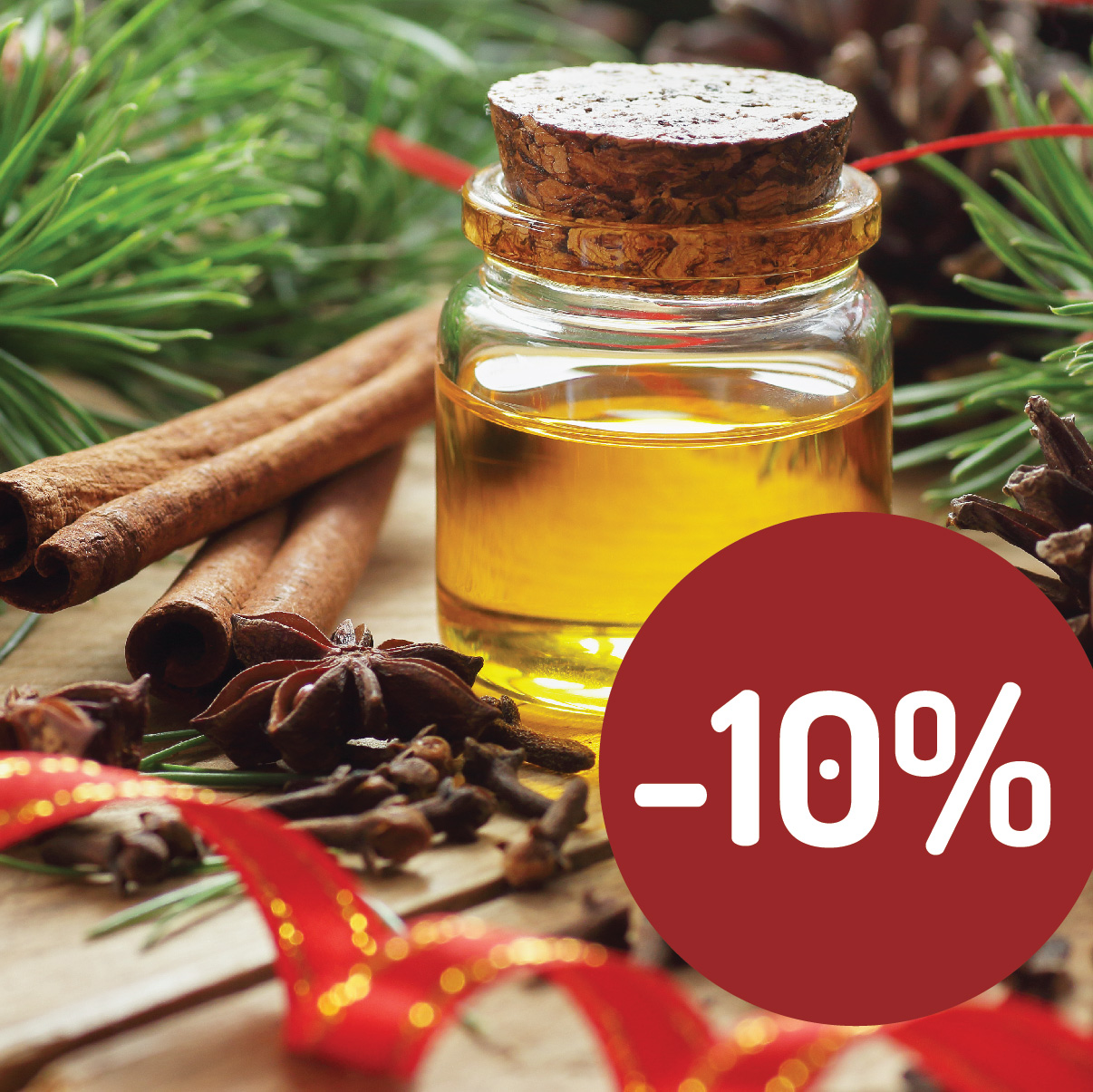 Štedré Vainoce v Handymade so zľavou -10% na všetky suroviny na tvorbu prírodnej kozmetiky s obrázkom oleja v sklenenej fľaške medzi ihličím a červenou stužkou či sušenými bylinkami.